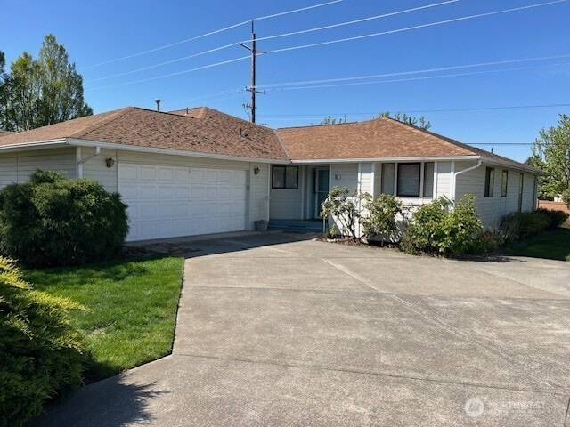 single story home with a garage and driveway
