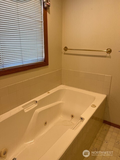 full bath with a whirlpool tub