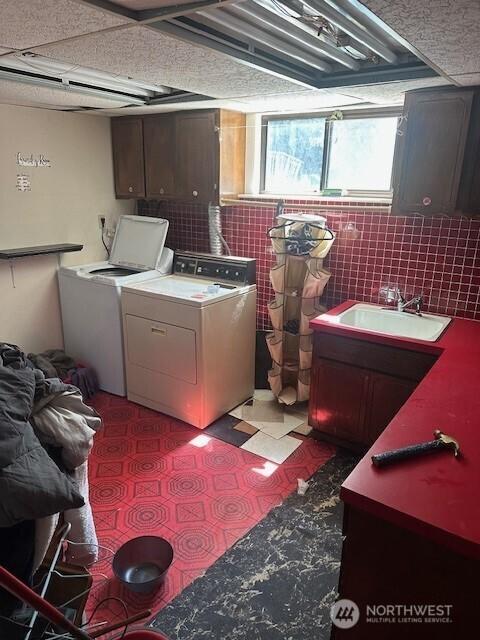 2232 177th Pl SW, Lynnwood, WA 98037 - laundry area with cabinet space, tile patterned floors, washing machine and clothes dryer, and a sink