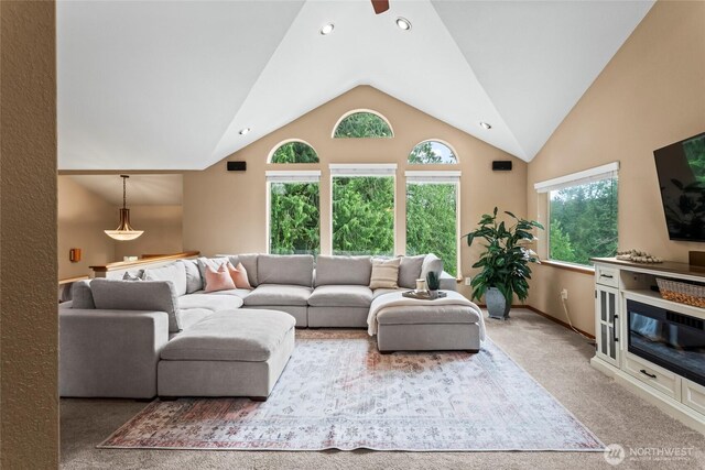 living area with carpet flooring, recessed lighting, baseboards, and lofted ceiling