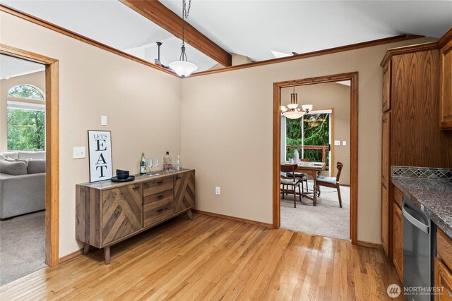 interior space with vaulted ceiling with beams, baseboards, an inviting chandelier, and light wood-style flooring