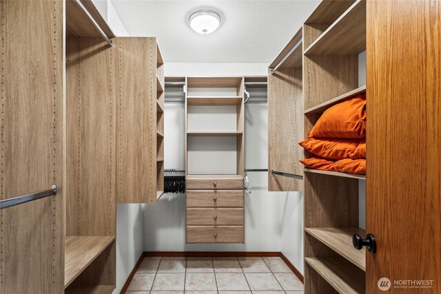spacious closet featuring light tile patterned floors