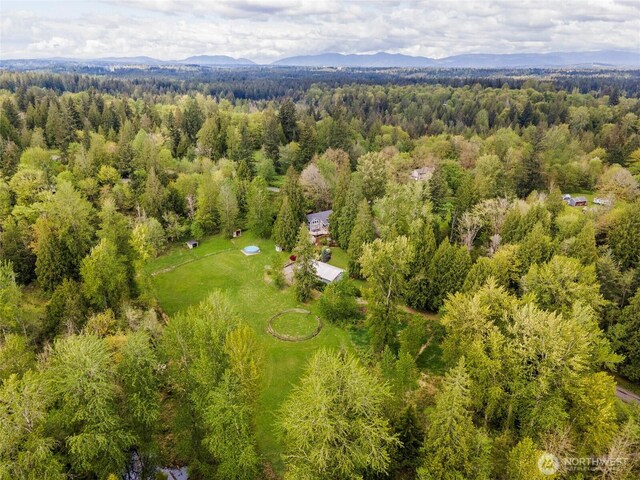 drone / aerial view with a mountain view and a forest view
