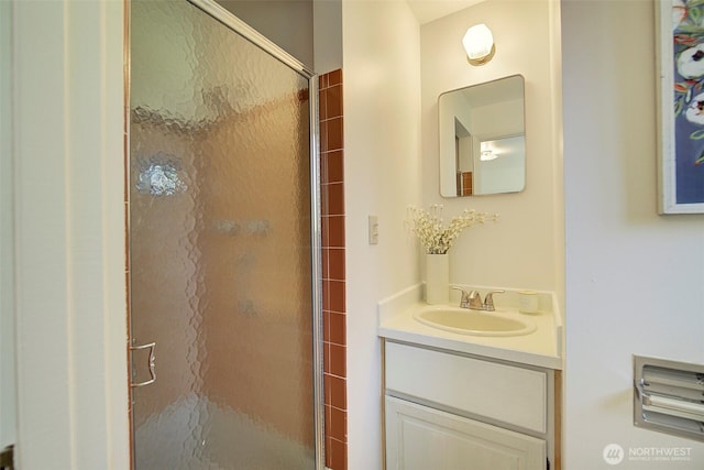 bathroom with a shower stall and vanity