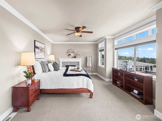 bedroom with crown molding, ceiling fan, carpet, baseboards, and visible vents