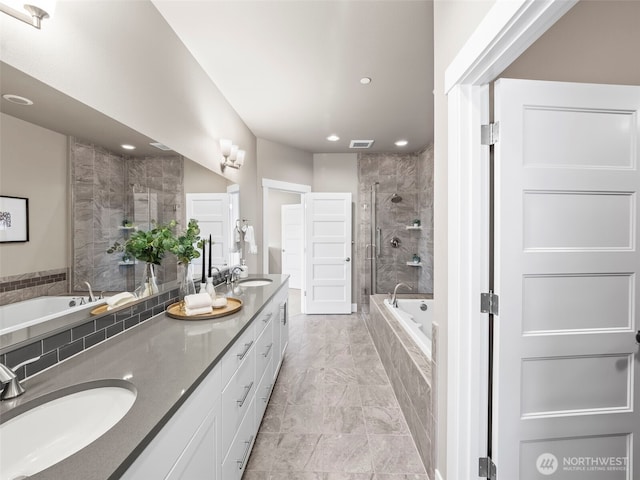 bathroom featuring a sink, a tile shower, tiled tub, and visible vents
