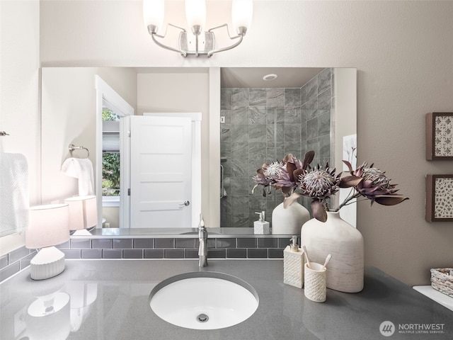 full bath with vanity and tiled shower
