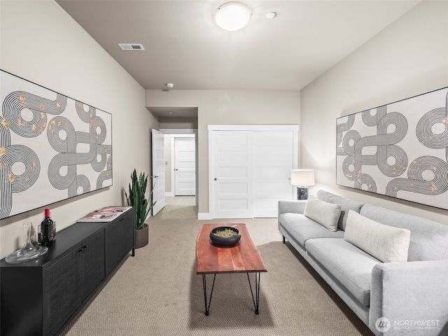 living room featuring visible vents, carpet flooring, and baseboards