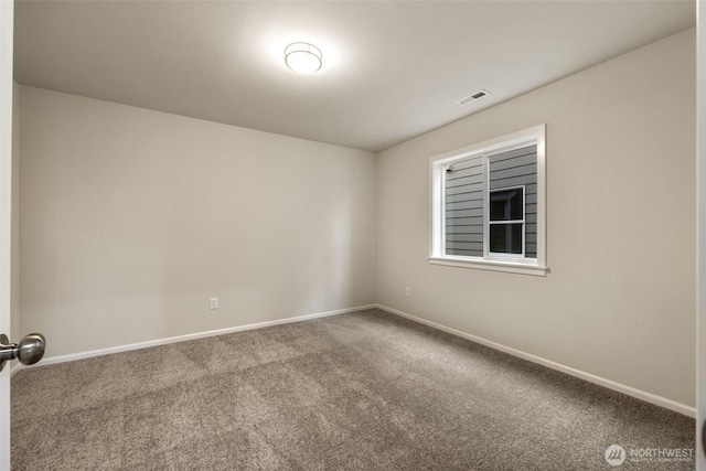 carpeted spare room featuring baseboards and visible vents