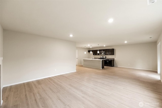 unfurnished living room with light wood-style floors, recessed lighting, baseboards, and visible vents
