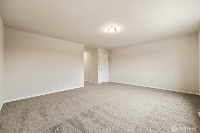 unfurnished room with baseboards and carpet