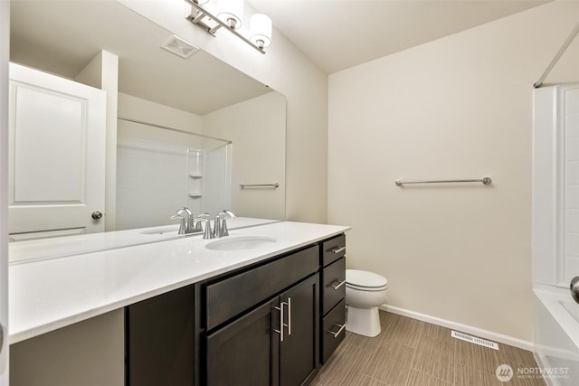 bathroom with visible vents, baseboards, toilet, and vanity