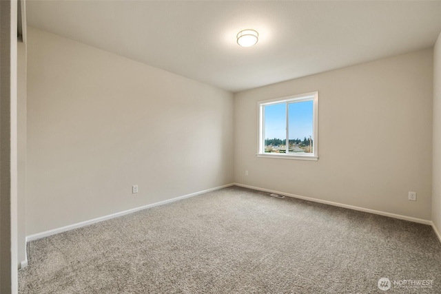 carpeted spare room with baseboards and visible vents