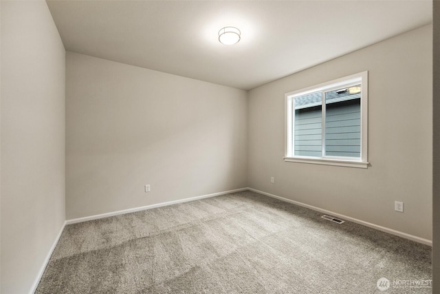 unfurnished room featuring baseboards, visible vents, and carpet