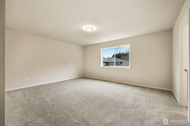 empty room with carpet floors and baseboards