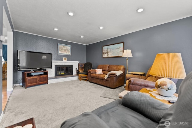 109 Lime St, Omak, WA 98841 - carpeted living room featuring crown molding, baseboards, a glass covered fireplace, and recessed lighting