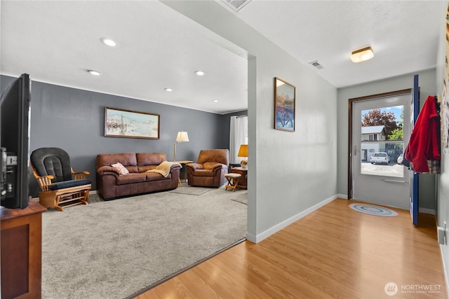 109 Lime St, Omak, WA 98841 - living room featuring recessed lighting, baseboards, visible vents, and wood finished floors