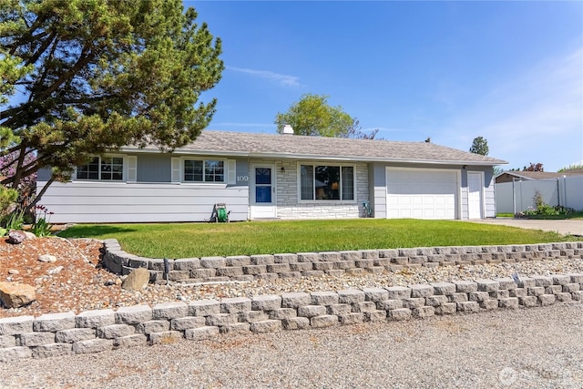 109 Lime St, Omak, WA 98841 - ranch-style house featuring a front lawn, fence, stone siding, concrete driveway, and an attached garage