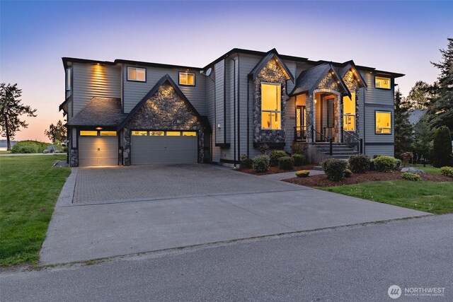1985 Bayview St, Blaine, WA 98230 - view of front of home featuring stone siding, driveway, a lawn, and an attached garage