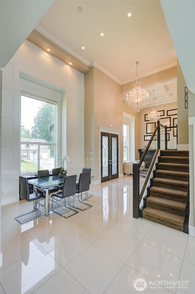 1985 Bayview St, Blaine, WA 98230 - entryway with a chandelier, crown molding, french doors, light tile patterned floors, and stairway