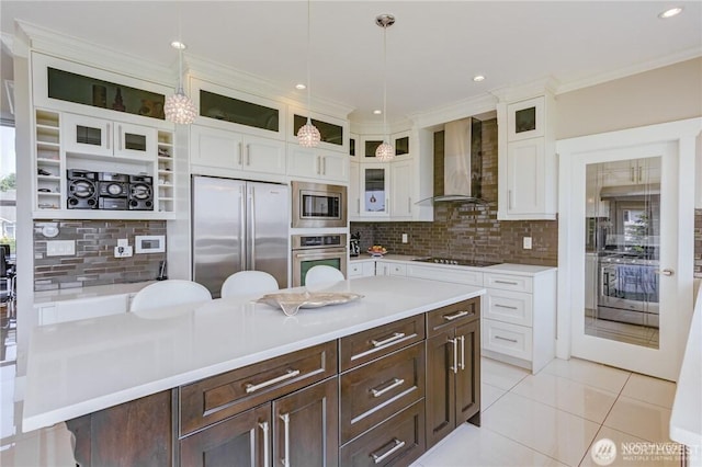 1985 Bayview St, Blaine, WA 98230 - kitchen with wall chimney exhaust hood, stainless steel appliances, dark brown cabinetry, decorative backsplash, and recessed lighting