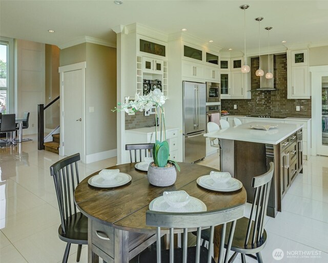 1985 Bayview St, Blaine, WA 98230 - dining space featuring light tile patterned flooring, stairway, recessed lighting, crown molding, and baseboards