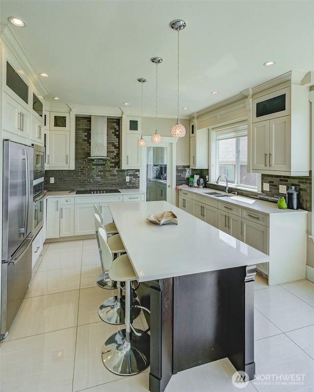 1985 Bayview St, Blaine, WA 98230 - kitchen with appliances with stainless steel finishes, backsplash, light tile patterned floors, wall chimney exhaust hood, and recessed lighting
