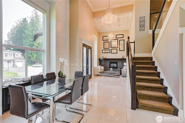 1985 Bayview St, Blaine, WA 98230 - tiled dining space with ornamental molding, stairs, a chandelier, plenty of natural light, and a high ceiling