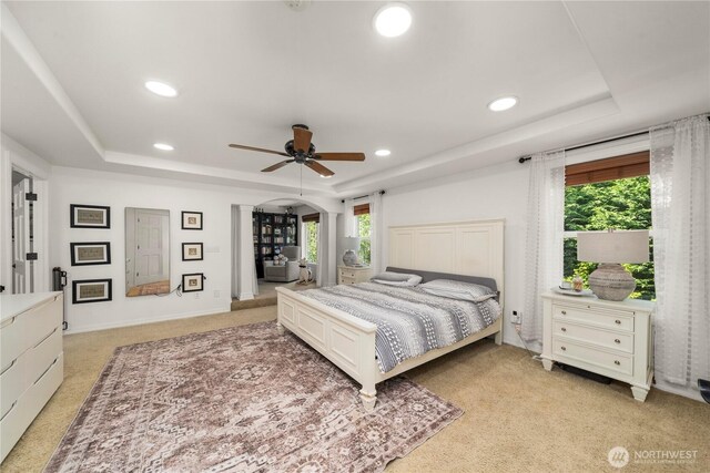 bedroom with recessed lighting, multiple windows, and a raised ceiling
