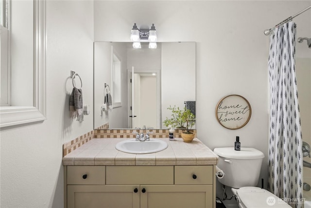 full bathroom featuring vanity and toilet
