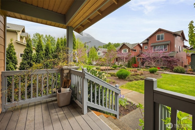 wooden deck with a residential view and covered porch