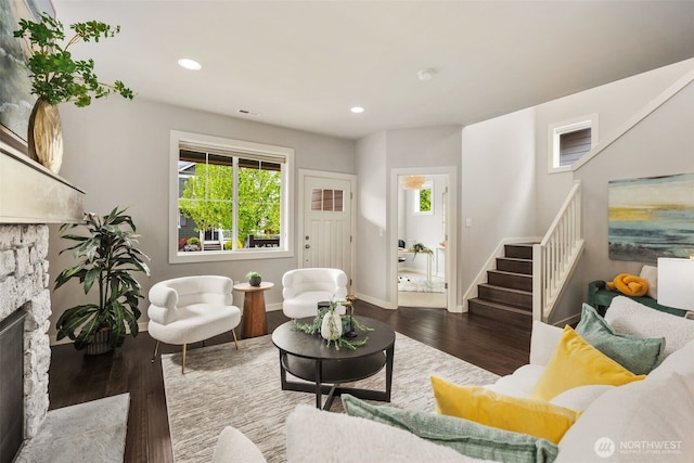 living area featuring a fireplace, stairs, recessed lighting, baseboards, and wood finished floors