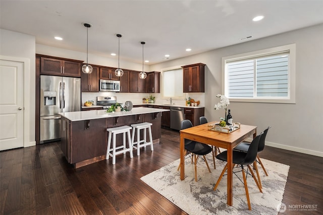dining area with recessed lighting and dark wood finished floors