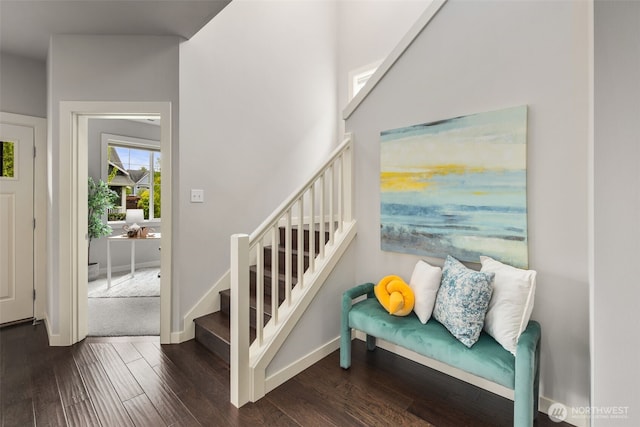 stairway featuring baseboards and wood finished floors