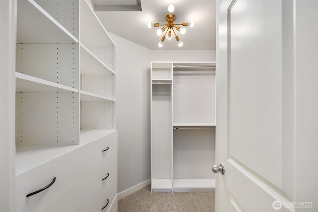 spacious closet featuring carpet floors and a notable chandelier