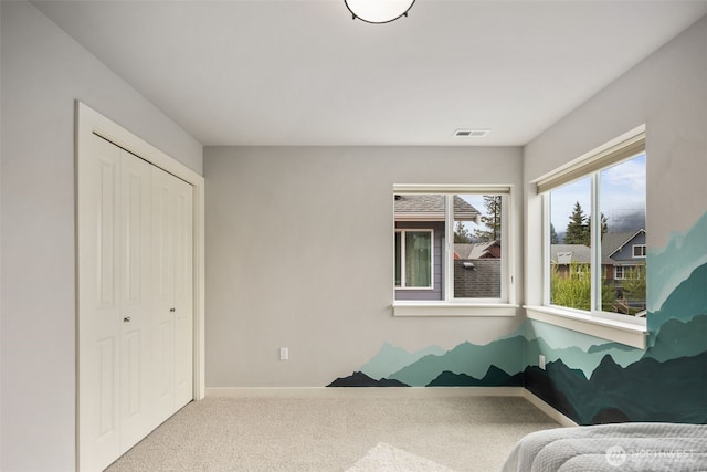 sitting room with carpet floors, baseboards, and visible vents