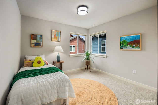 bedroom with baseboards and carpet