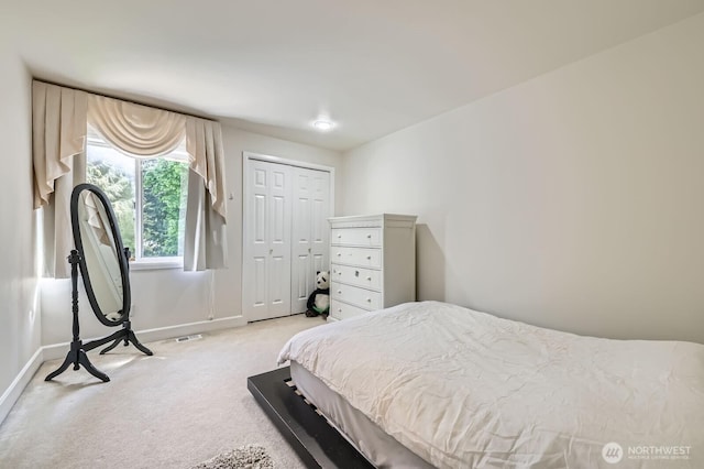 20933 37th Ave SE, Bothell, WA 98021 - bedroom featuring light colored carpet, baseboards, and a closet