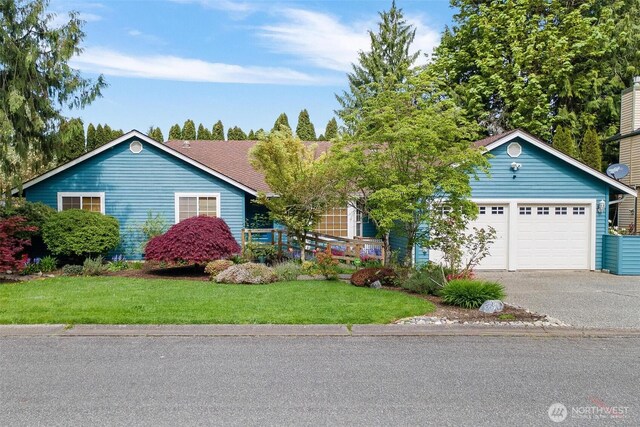ranch-style house featuring driveway, a front yard, and a garage