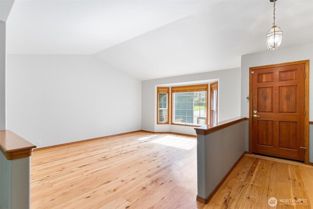 entrance foyer with light wood-type flooring and lofted ceiling