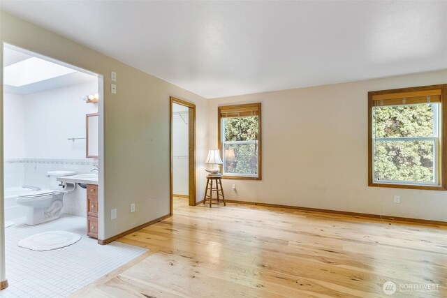 unfurnished room featuring light wood-style floors