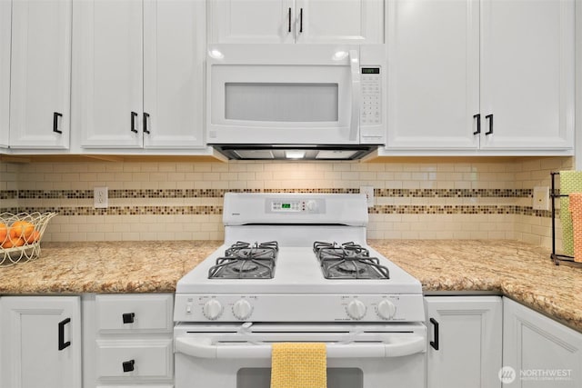 kitchen featuring decorative backsplash, white cabinets, white appliances, and light stone counters