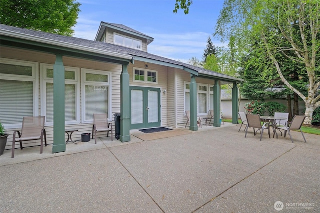 back of house featuring a patio, french doors, outdoor dining area, and roof with shingles