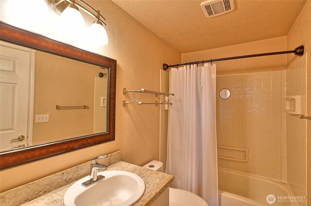 full bath with shower / bath combination with curtain, visible vents, vanity, toilet, and a textured wall