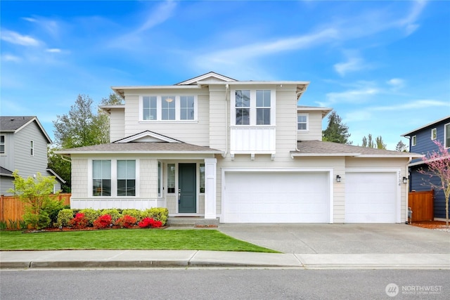 traditional-style house with a garage, a front lawn, fence, roof with shingles, and driveway
