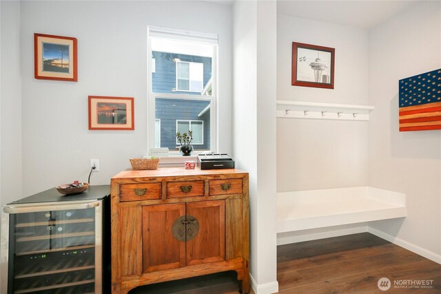mudroom featuring dark wood-style flooring, baseboards, and wine cooler
