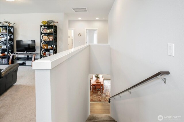 stairway with carpet floors, recessed lighting, and visible vents