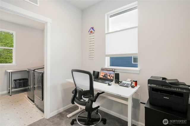 office area with separate washer and dryer, baseboards, and visible vents