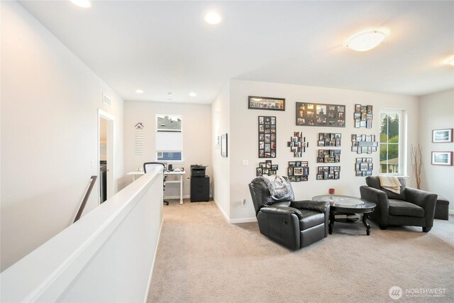 living area with baseboards, light carpet, recessed lighting, and visible vents