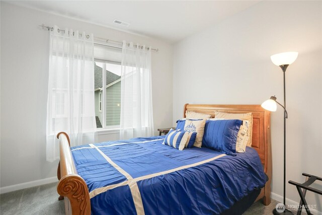 bedroom with carpet floors, baseboards, and visible vents